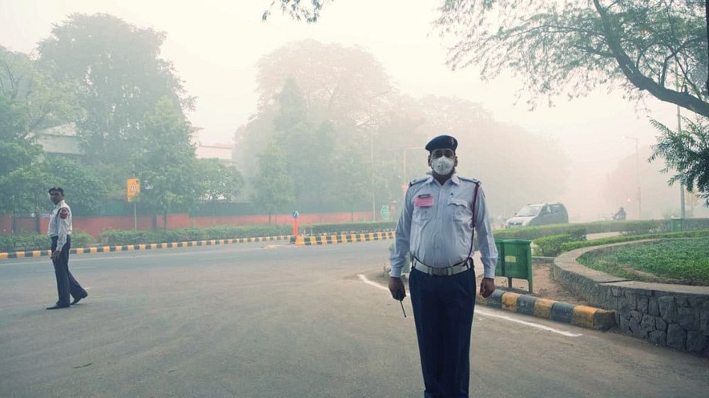 A traffic police on duty on a smog-filled morning.