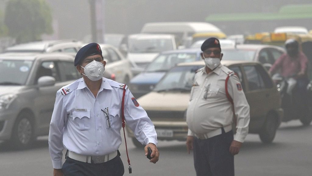 Traffic policemen wear masks to protect themselves from heavy smog and air pollution while manning the traffic in New Delhi.