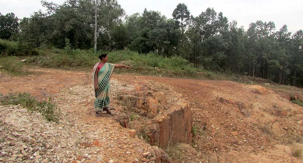 Sarojini, one of the widows, pointing at the mining area. 