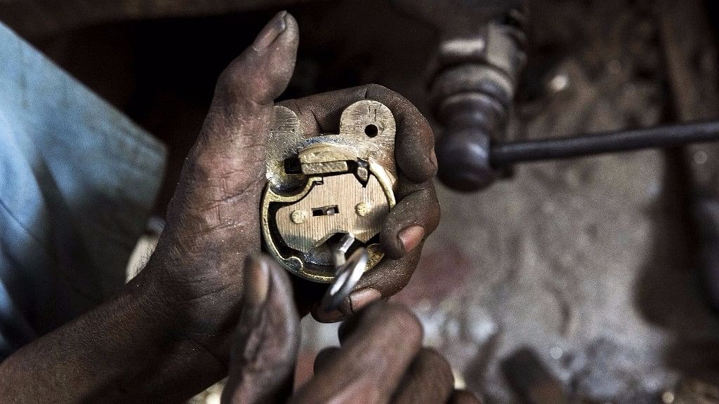 A worker manufactures a lock at a workshop in Aligarh, Uttar Pradesh, India.&nbsp;