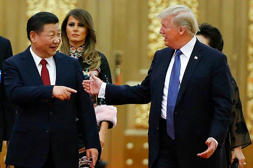 US President Donald Trump and China’s President Xi Jinping arrive for the state dinner with the first ladies at the Great Hall of the People in Beijing on 9 November 2017.