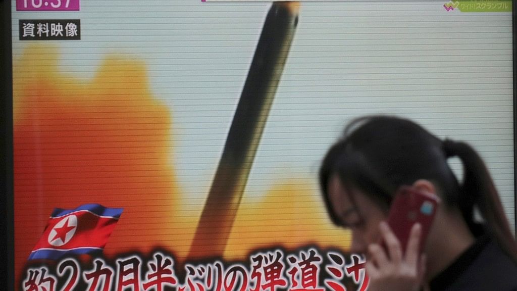 A woman walks past TV screen broadcasting reports on the launch of an ICBM in North Korea on Wednesday, 29 November.