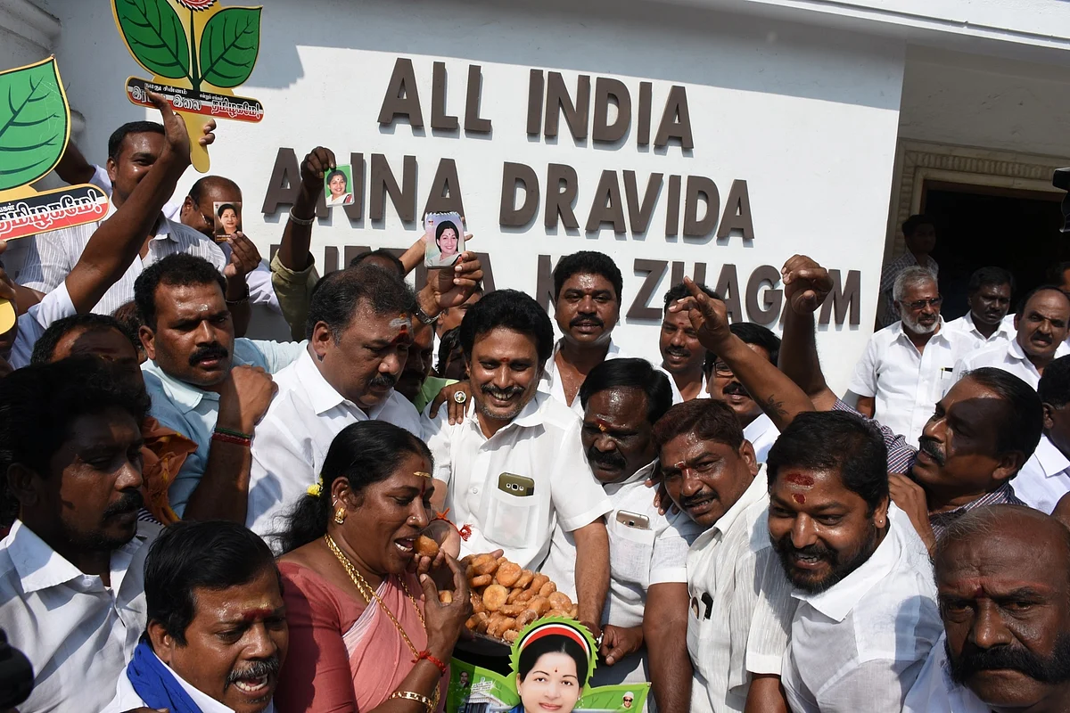 AIADMK workers of the ruling faction celebrate after the Election Commission decided to allot the ‘two leaves’ election symbol to the party in Chennai.
