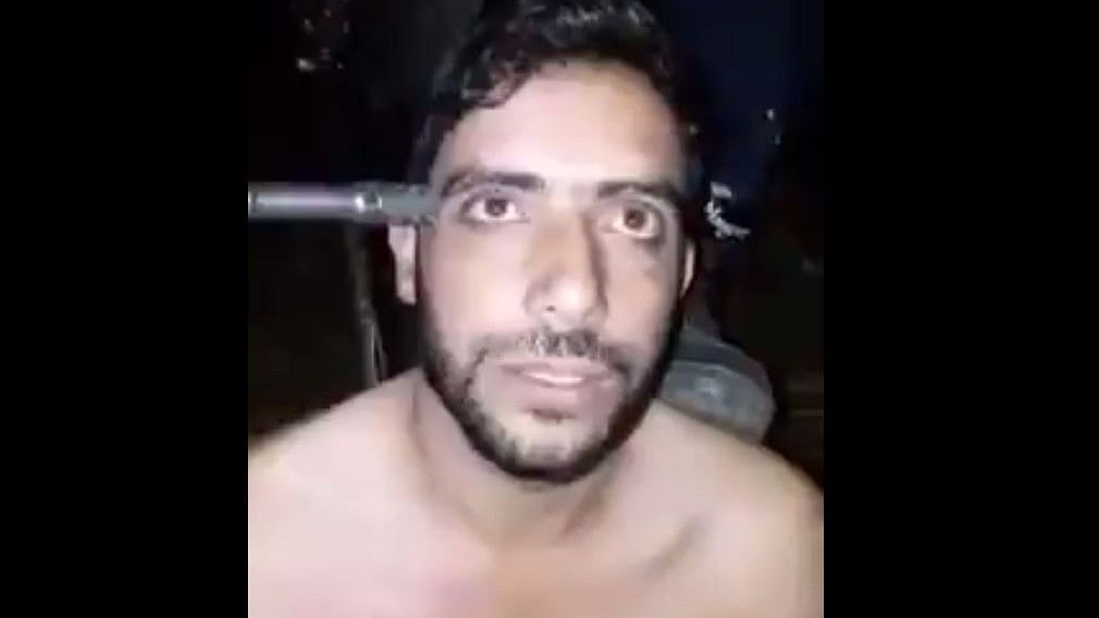 In the video, Ahmad is stripped, beaten and threatened at gunpoint
