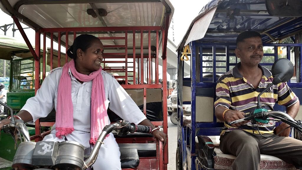 Binota maintains a good rapport  with her  fellow e-rickshaw drivers.