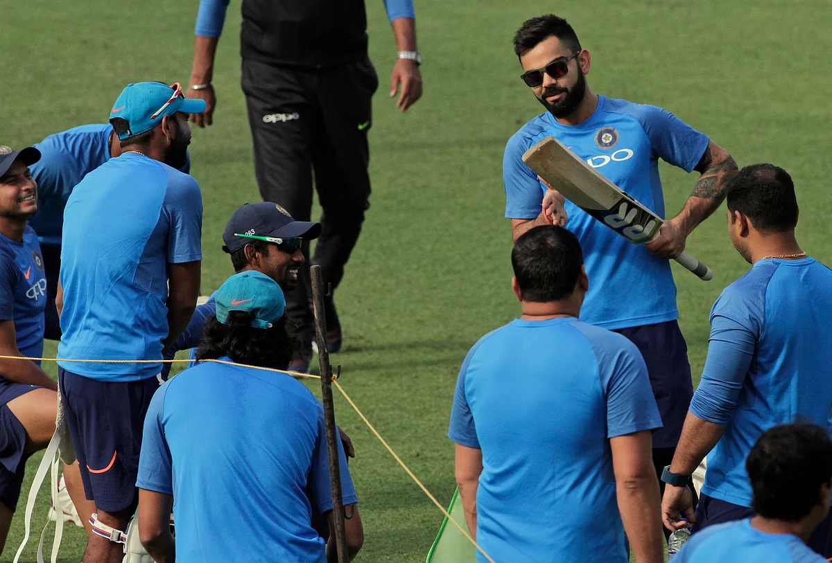 Virat Kohli speaks to his team during a training session in Kolkata. 