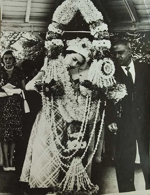 Queen Elizabeth II examining a giant garland in India, in 1961.
