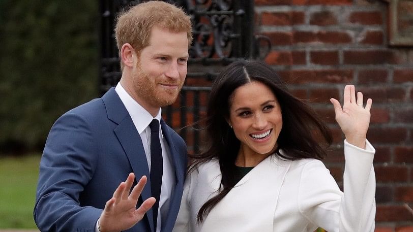Britain’s Prince Harry and his fiancee Meghan Markle pose for photographers during a photocall in the grounds of Kensington Palace in London, on Monday, 27 November.