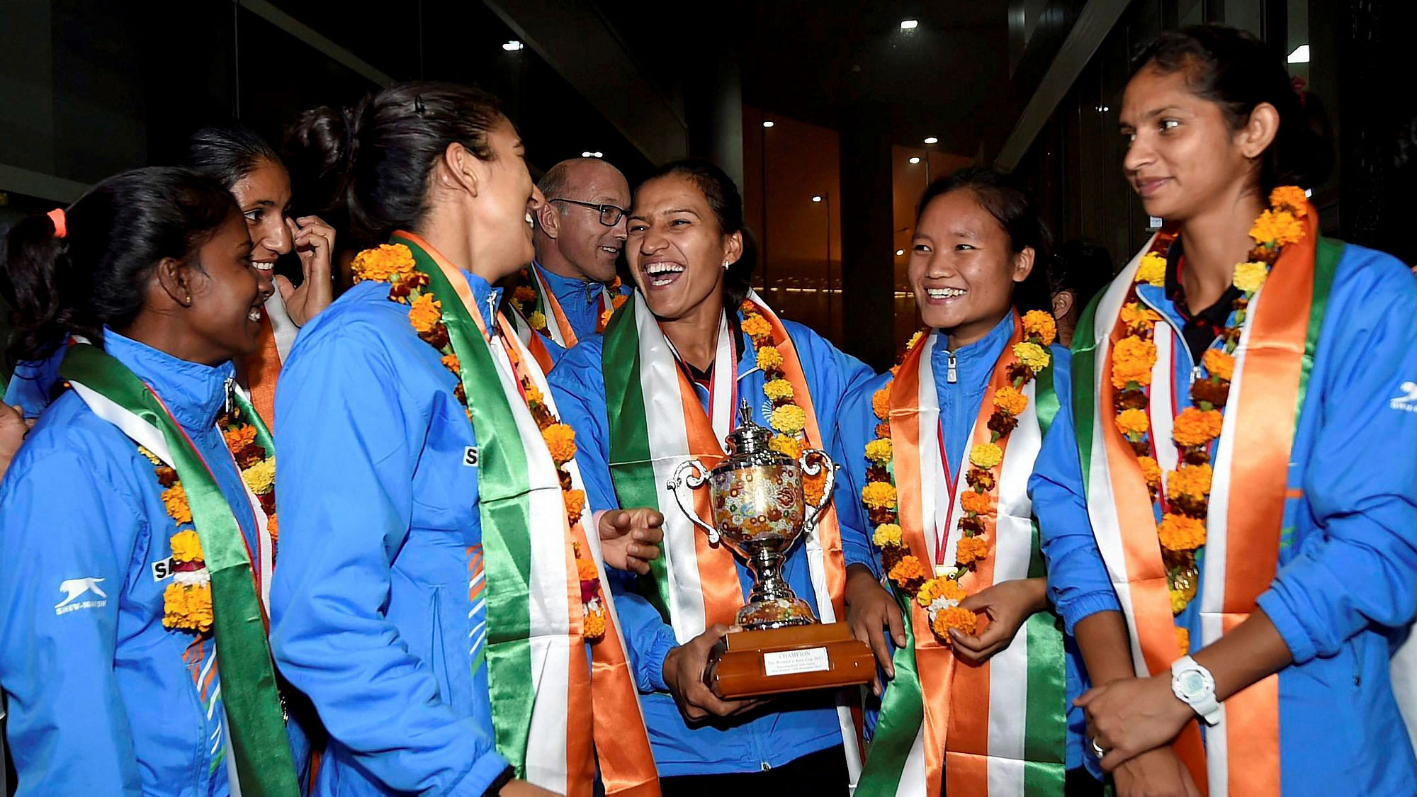 The Indian women’s hockey team pose with the Asia Cup 2017 trophy after their arrival at IGI Airport in New Delhi on Monday, 6 November.