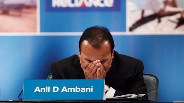 Chairman of debt-riddled Reliance Communications, Anil D Ambani hangs his head at a press conference.