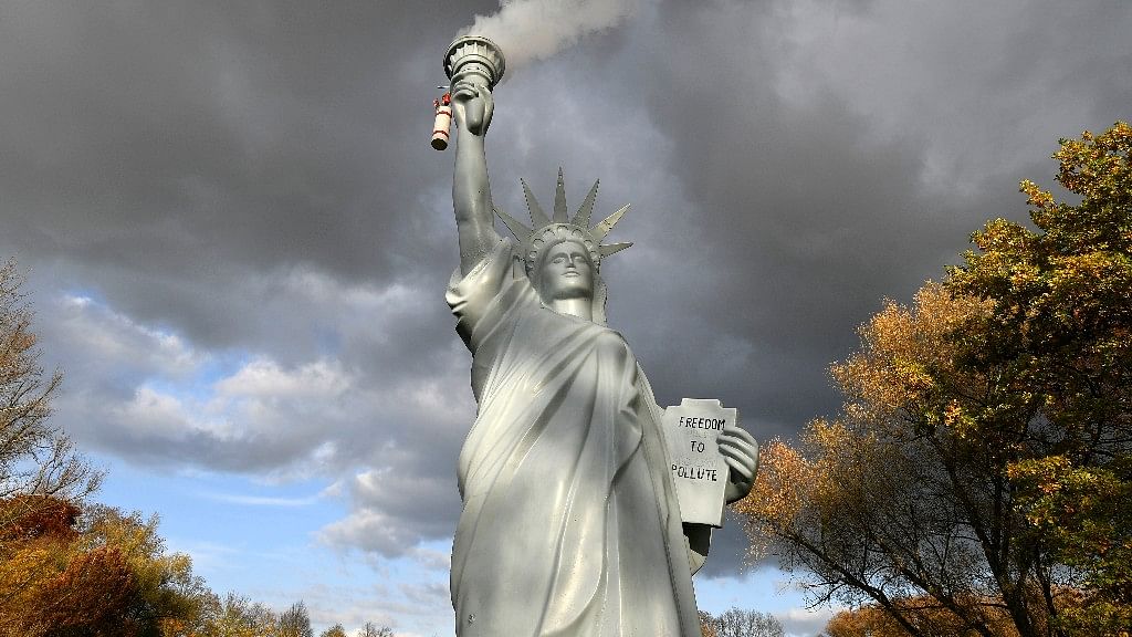 A replica of the Statue of Liberty  emits smoke in a park outside the 23rd UN Conference of the Parties  climate talks in Bonn, Germany, 17 November, 2017.