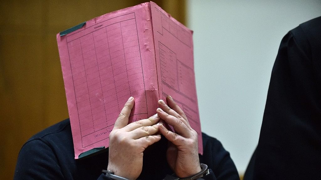  File photo shows former nurse Niels H covering his face during his trial at the regional court in in Oldenburg, northern Germany.
