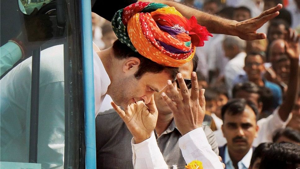 Congress Vice-President Rahul Gandhi being presented a turban by the supporters during a road show in Banaskatha, Gujarat.