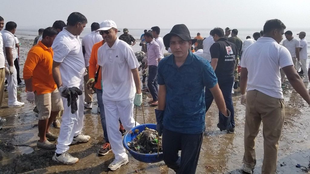 Afroz Shah cleans up Mumbai’s Versova beach with other volunteers.