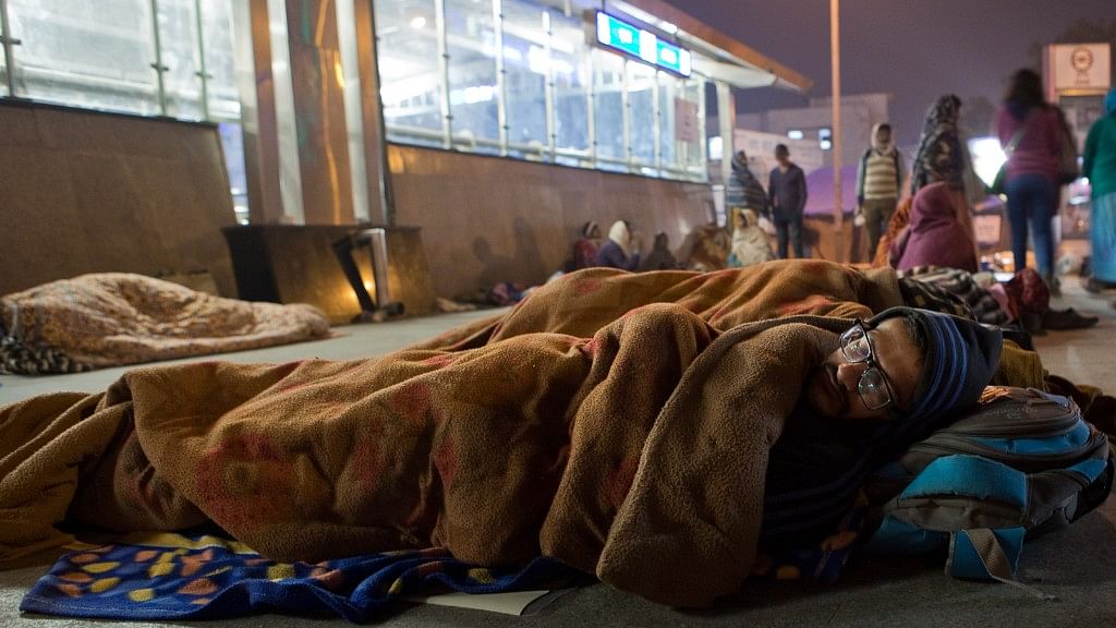 A man sleeping outside the AIIMS metro station in New Delhi.&nbsp;