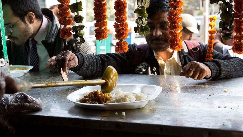 A man waits for rice and chickpeas to be served at the Rs 10 Jan Aahar scheme stall.&nbsp;