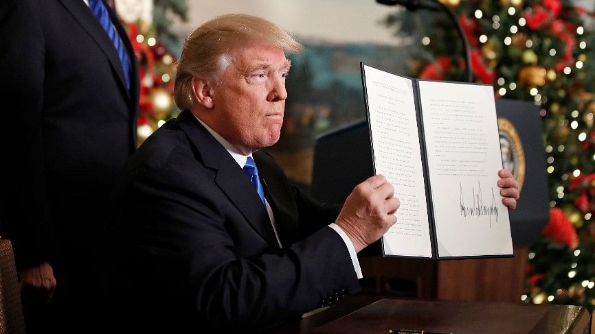 US President Donald Trump holds up a proclamation to officially recognize Jerusalem as the capital of Israel.