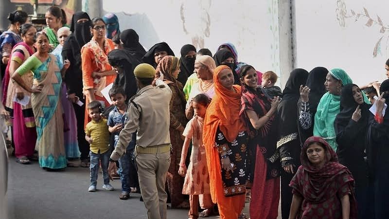 Picture of voters standing in line to cast their vote during the second phase of the Gujarat Assembly Elections.
