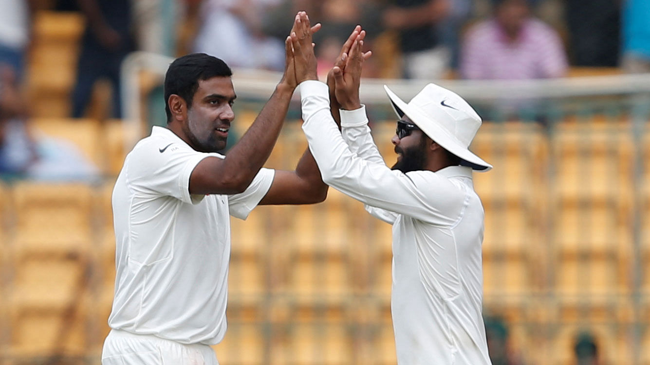 Ravichandran Ashwin and Ravindra Jadeja celebrate a wicket during a Test match.