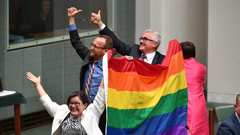 Members of Australian parliament celebrate the passing of the Marriage Amendment Bill in the House of Representatives at Parliament House.