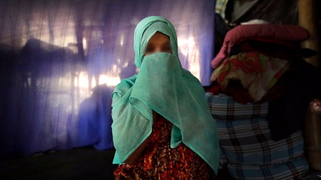  F, 22, pregnant, prays in her tent in Kutupalong refugee camp in Bangladesh.