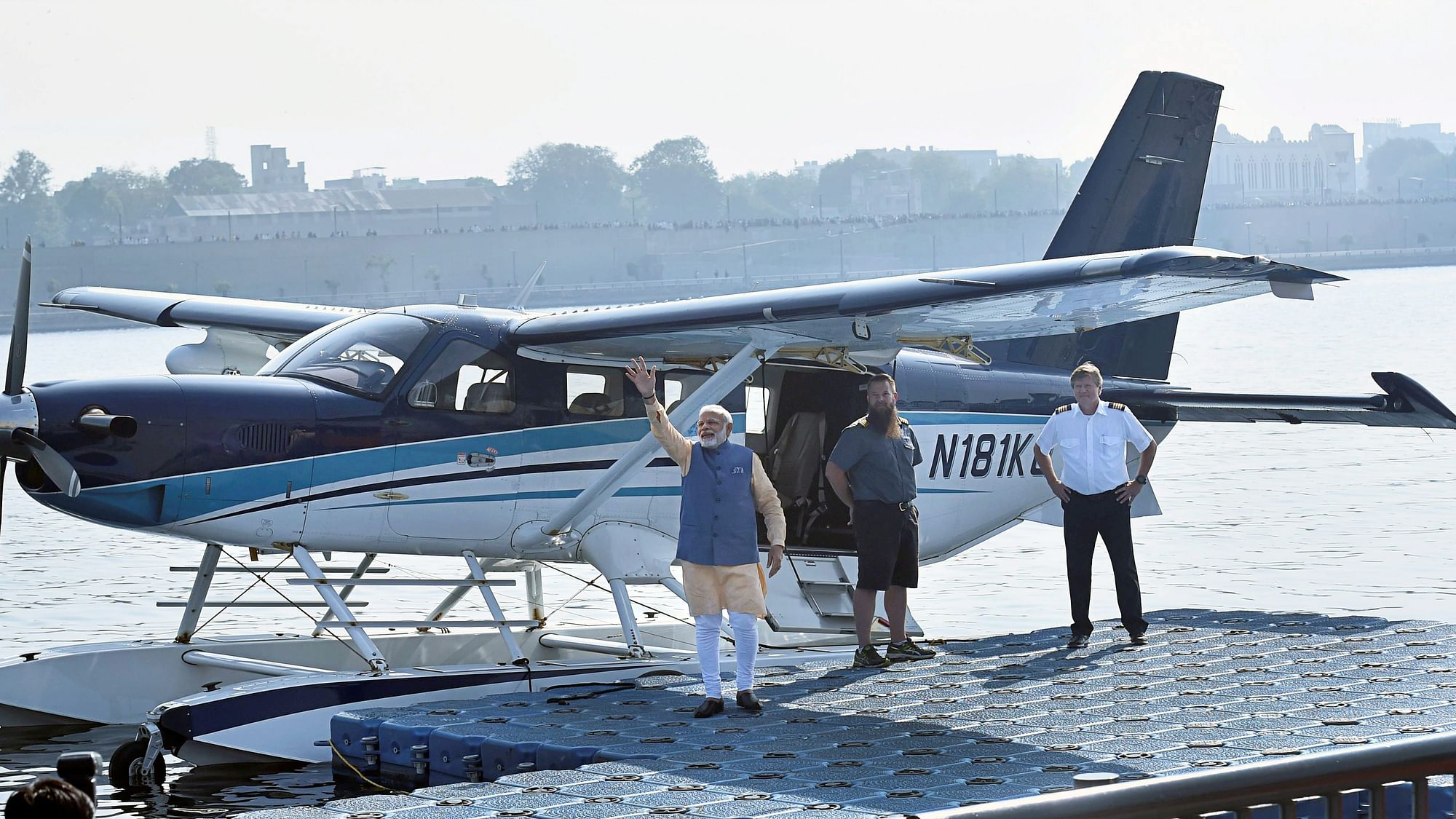 Prime Minister Narendra Modi waves to the crowd as he boards a seaplane on the Sabarmati river front in Ahmedabad on Tuesday. 
