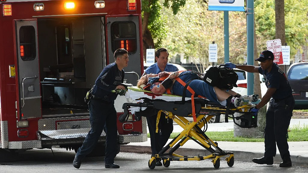 An injured woman is taken into Broward Health Trauma Center in Fort Lauderdale after the shooting.