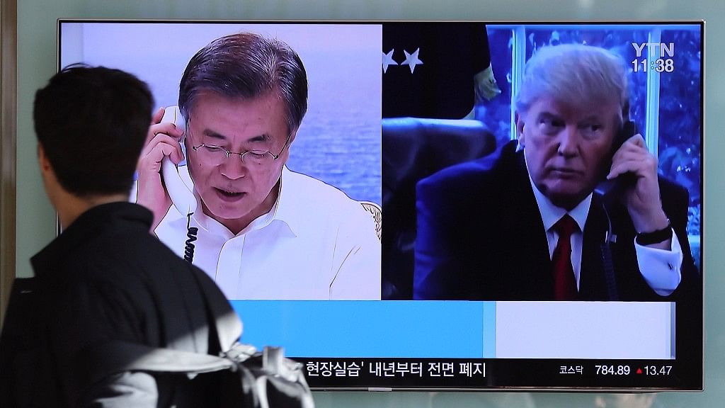 A man walks by a TV screen showing a local news program reporting about North Korea’s missile launch with an images of US President Donald Trump and South Korean President Moon Jae-in at the Seoul Railway Station in Seoul, South Korea.