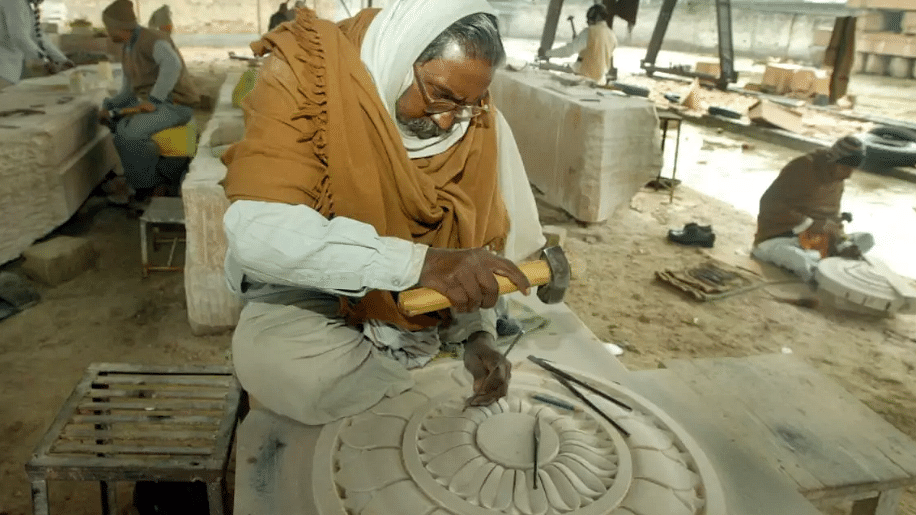 Sculptors carving a stone in a workshop in Ayodhya.