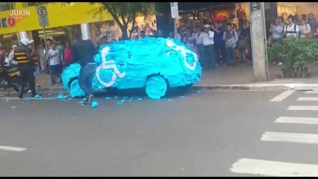After a man parked his car in the disabled parking area, his car gets covered with blue and white post-it notes.