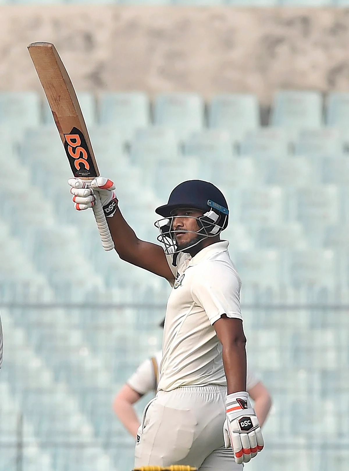 Vidarbha batsman Ganesh Satish celebrates after completing his half century during their 3rd day of the Ranji Trophy semi-final against Karnataka at Eden Garden in Kolkata