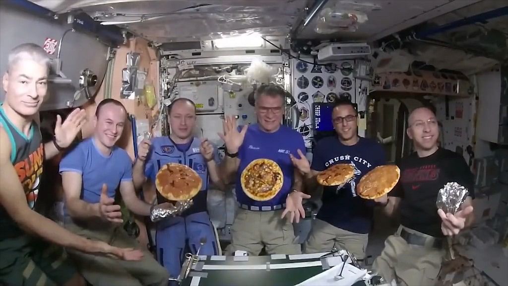 Astronauts at ISS with their pizzas