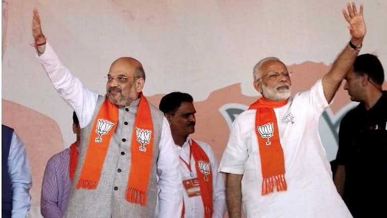 Prime Minister Narendra Modi with BJP President Amit Shah waves at crowd in Ahmedabad.&nbsp;
