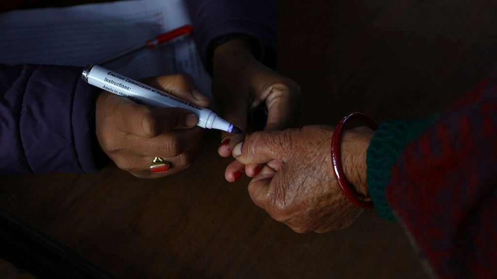 A woman gets her thumb inked to cast her vote.&nbsp;