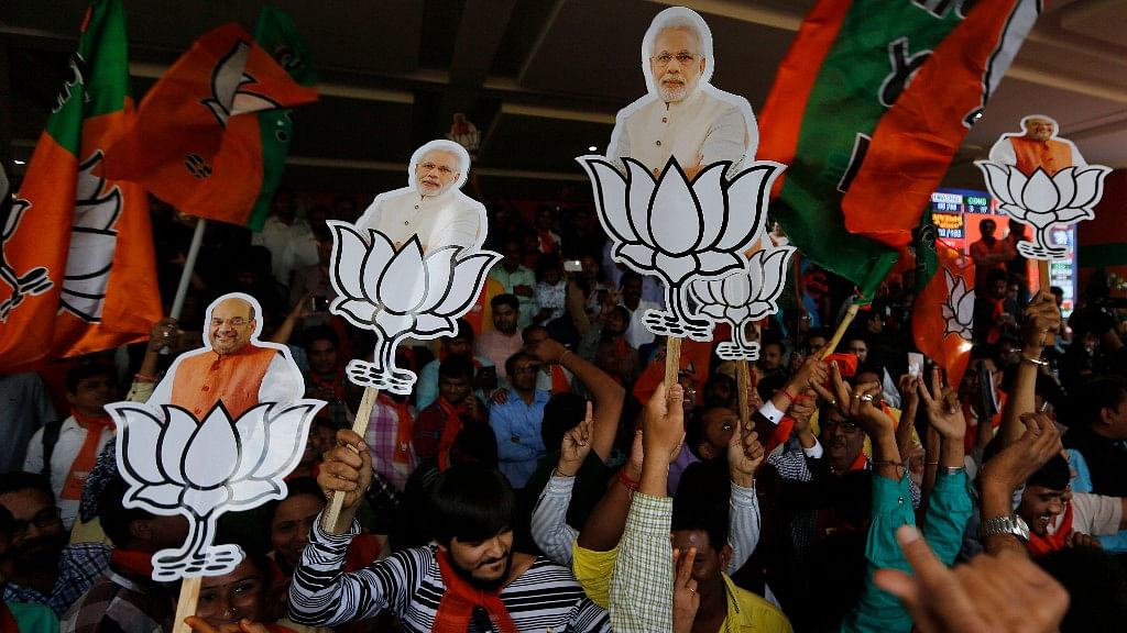 Supporters of BJP celebrate their party’s victory in Gujarat state Assembly elections in Gandhinagar.