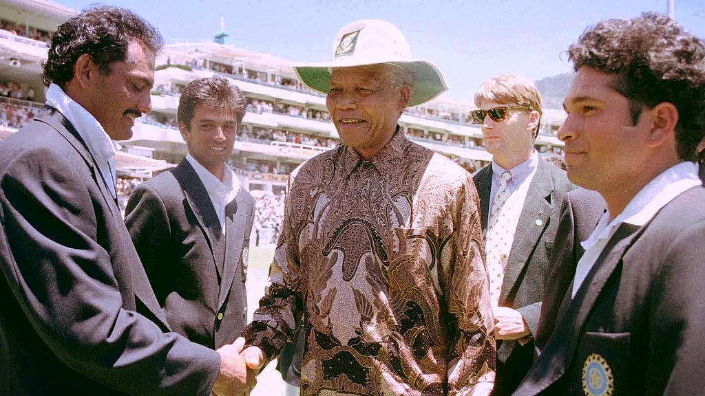The then South African President Nelson Mandela (C) is introduced to Mohammad Azharuddin (L) by the then Indian captain Sachin Tendulkar (R) in 1997.