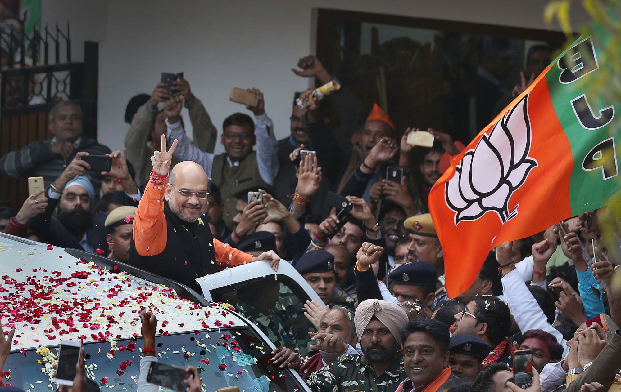 BJP President Amit Shah shows a victory sign on his arrival at the party headquarters in New Delhi.