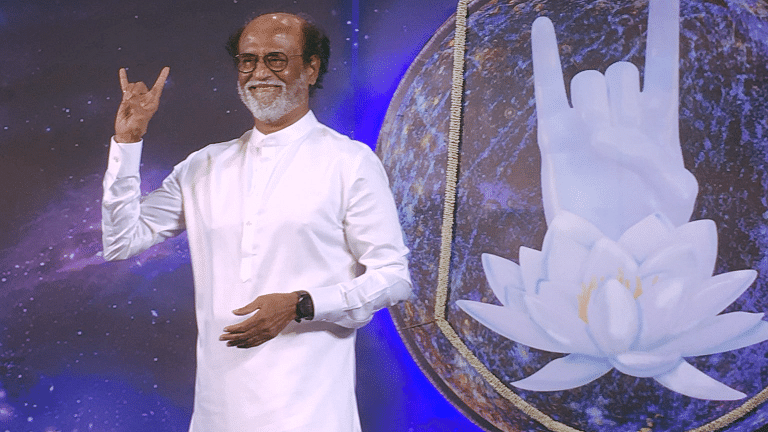 Rajini makes the “baba” symbol, a trademark of his character from the movie <i>Baba</i>.