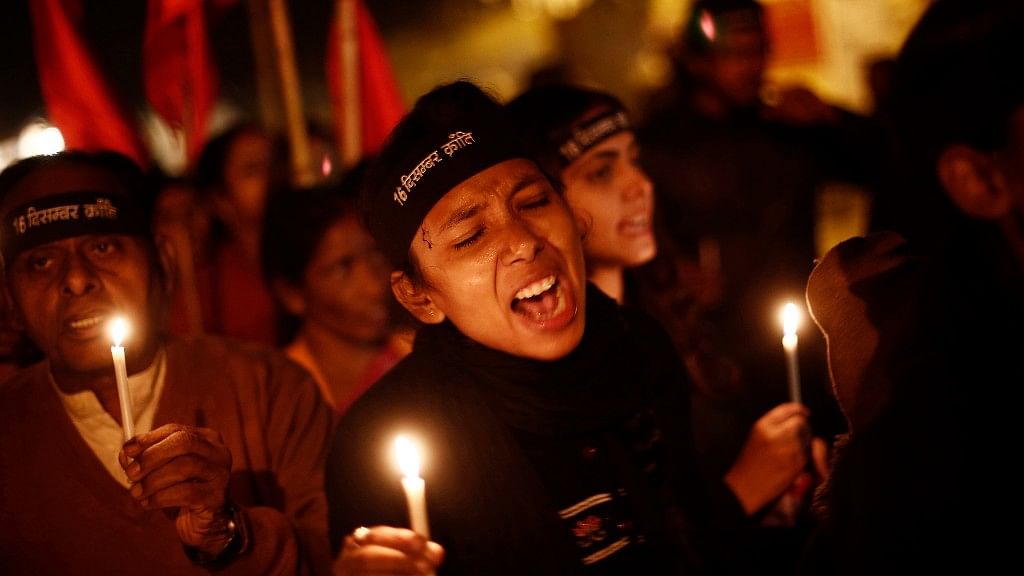 Protestors shout slogans at a candlelight vigil in New Delhi on the first anniversary of the 16 December 2012 Delhi gang rape.