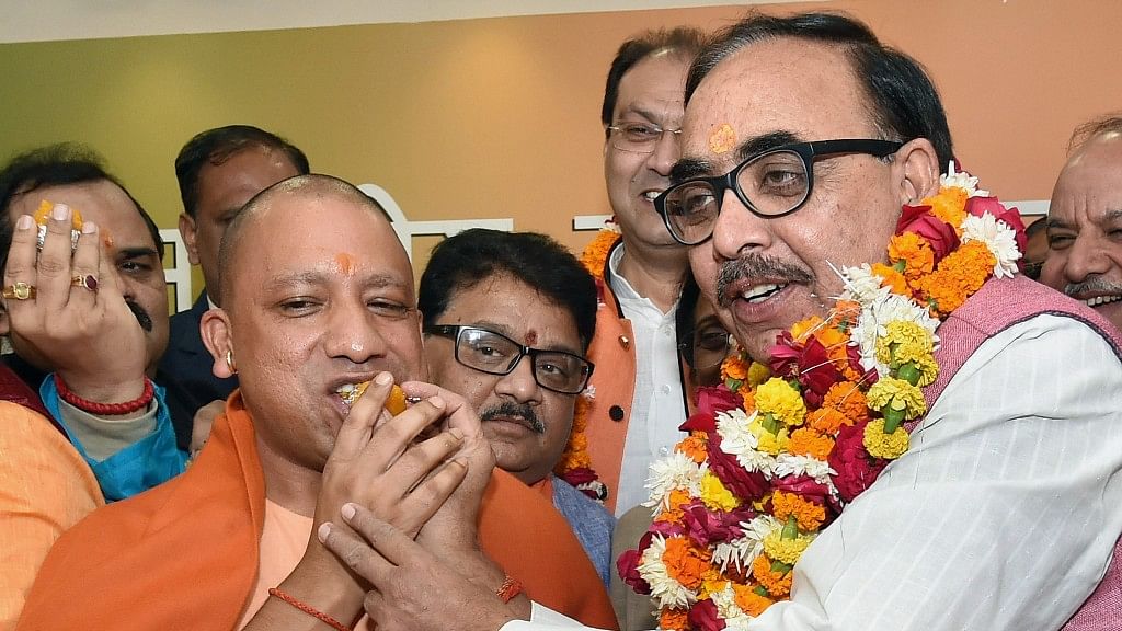 Uttar Pradesh Chief Minister Yogi Adityanath and BJP State President Mahendra Nath Pandey celebrate the victory of the party in the state civic body elections at the party office in Lucknow on Friday.