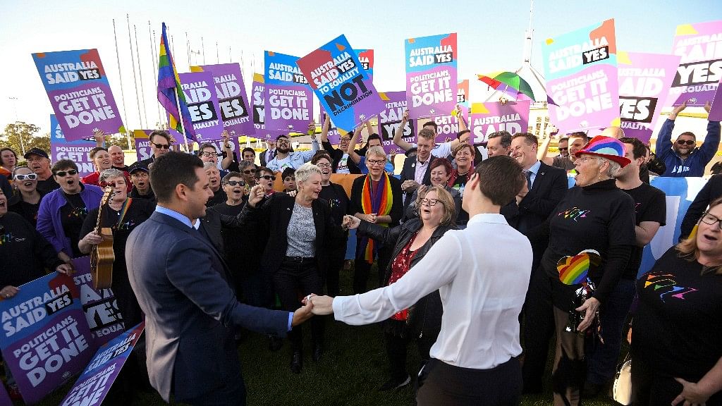 Same-sex marriage campaigners cheer during rally outside Parliament House in Canberra, Australia.