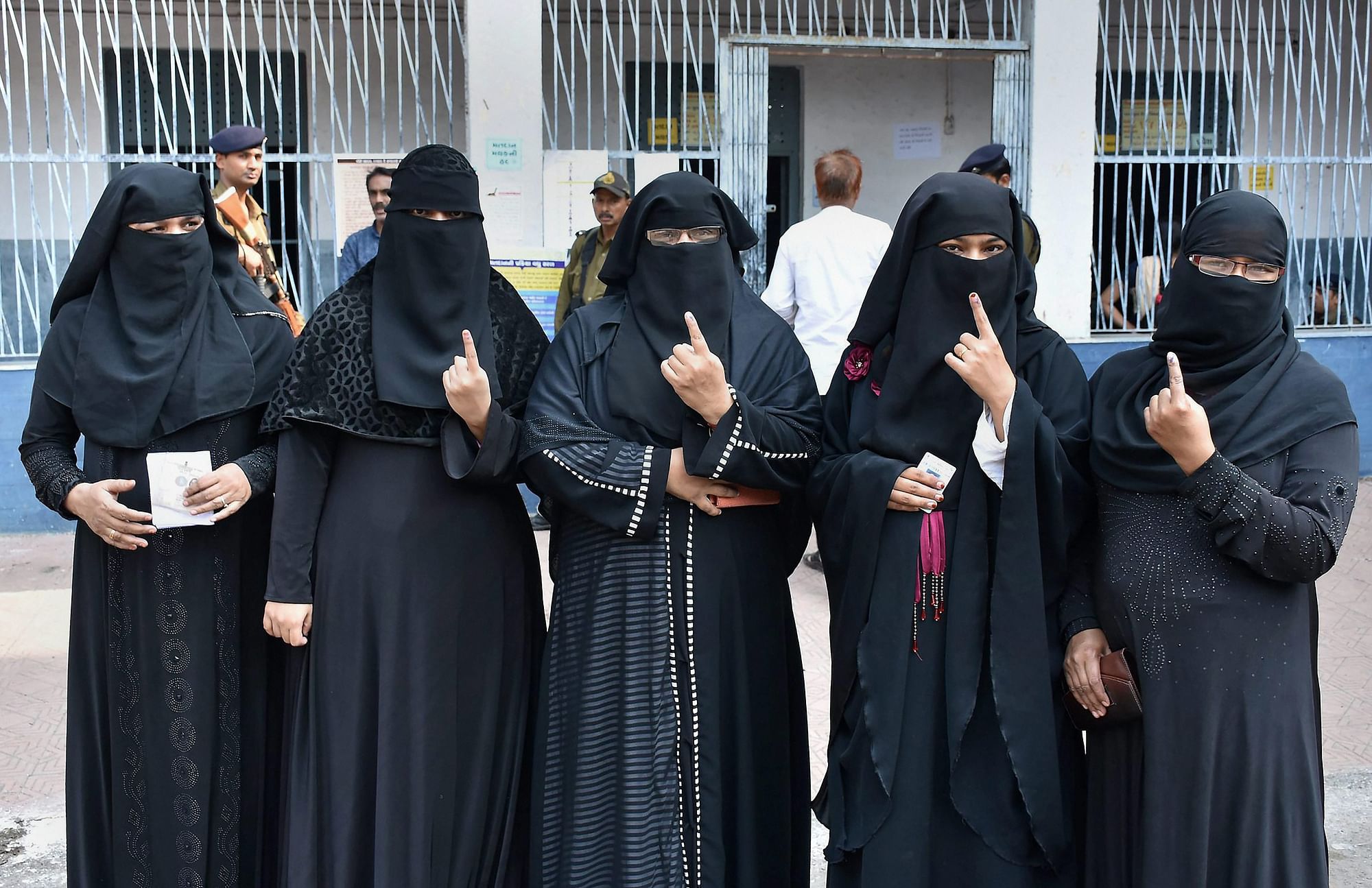 Muslim voters showing their inked fingers at a polling booth during Gujarat Assembly election in Surat.