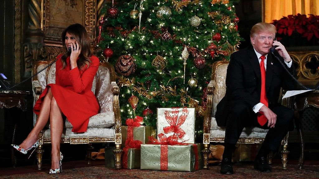 President Donald Trump and first lady Melania Trump speak on the phone with children as they track Santa Claus’ movements with the North American Aerospace Defense Command (NORAD) Santa Tracker on Christmas Eve at the president’s Mar-a-Lago estate in Palm Beach, Fla.