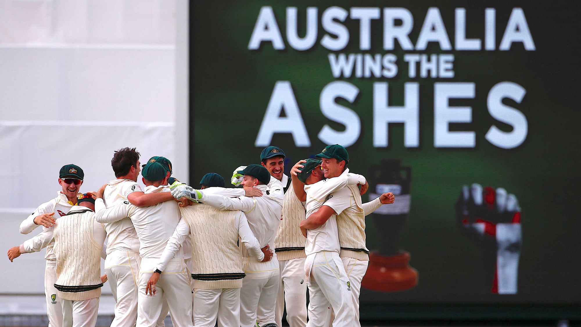 Australian players celebrate after winning the third Ashes test match at Perth.