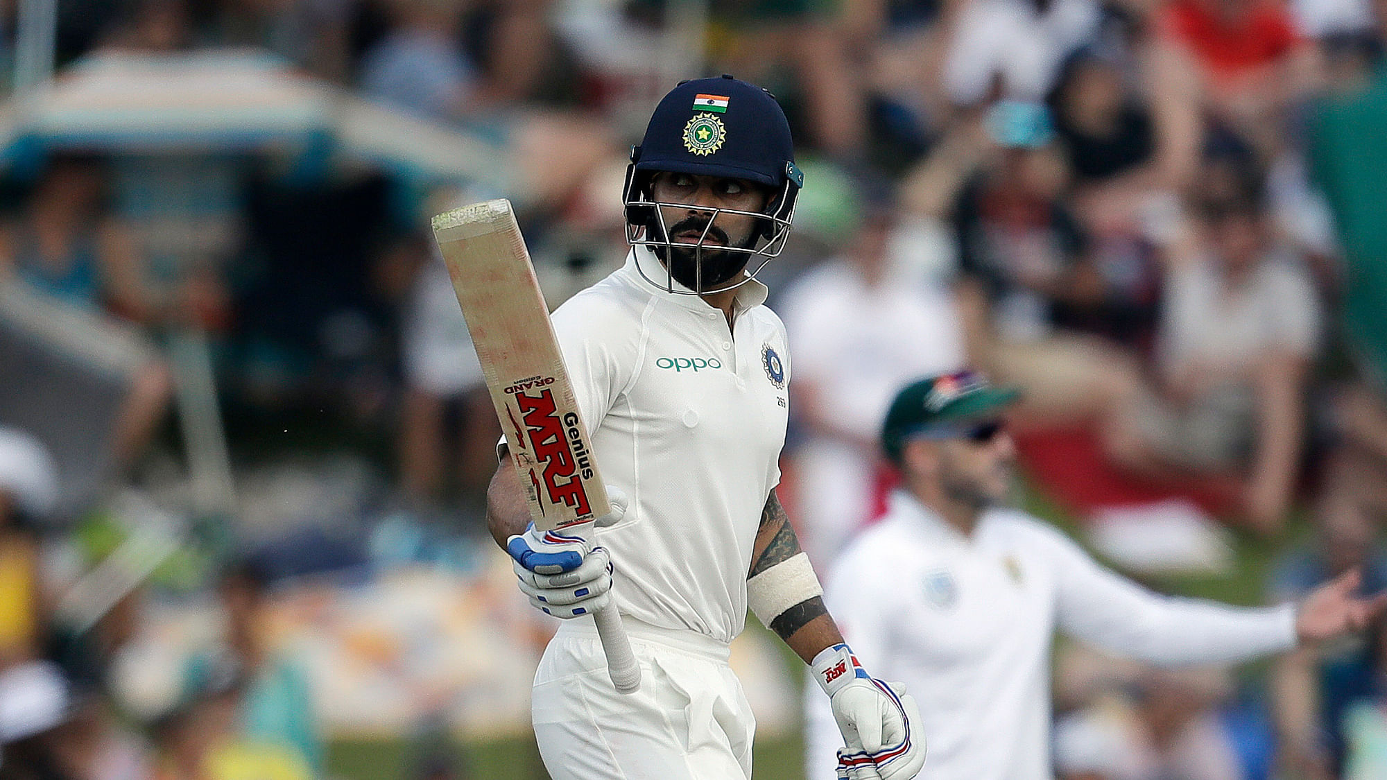 India’s captain Virat Kohli, raises his bat after reaching half century during the second day of the second cricket test match between South Africa and India at Centurion Park in Pretoria, South Africa