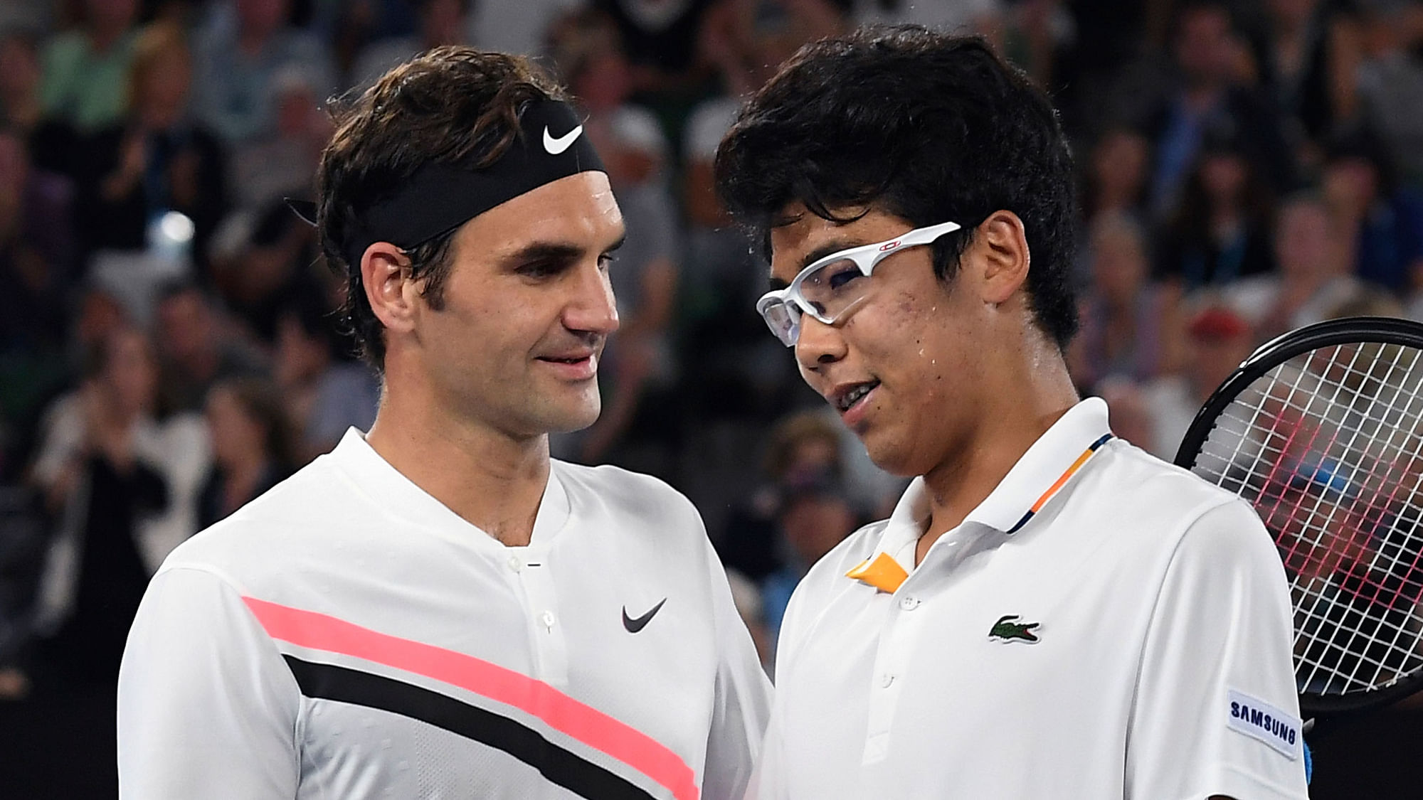 Switzerland’s Roger Federer, left, is congratulated by South Korea’s Hyeon Chung after their semi-final match.