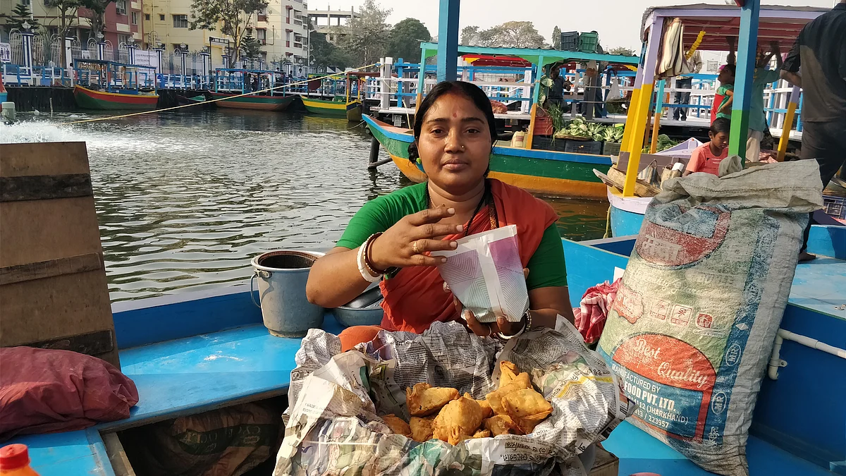 Archana Sikdar packs some samosas for a customer.