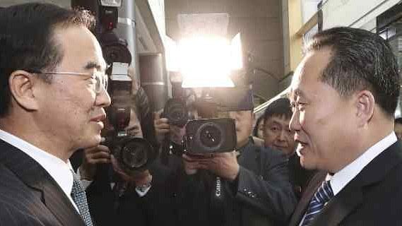South Korean Unification Minister Cho Myoung-gyon (L), shakes hands with the head of North Korean delegation Ri Son Gwon before their meeting at the Panmunjom, on 9 January.