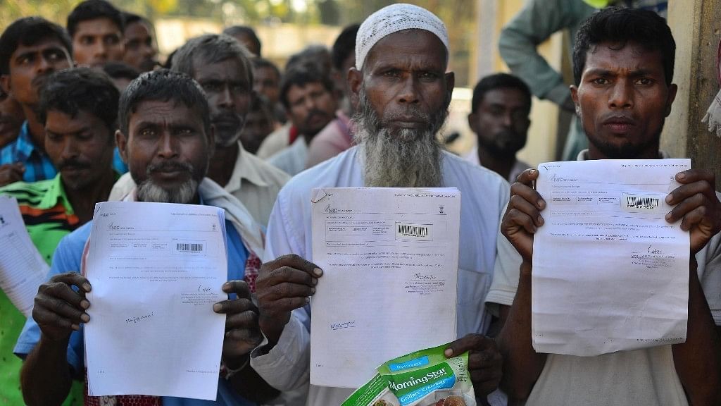 A file photo of people showing their acknowledgement receipts after checking their names in a draft for National Register of Citizens (NRC), in Guwahati.&nbsp;