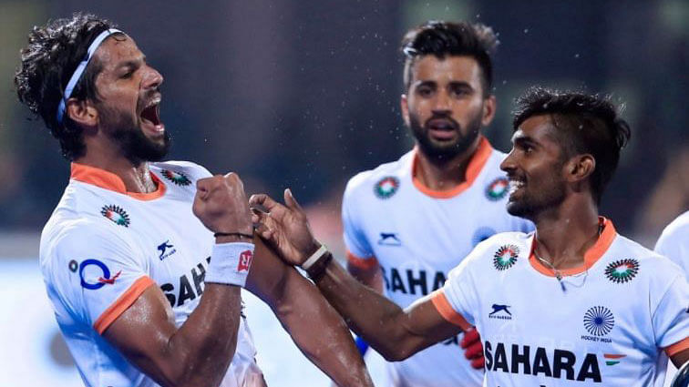 Rupinder Pal Singh celebrates a goal with his teammates.
